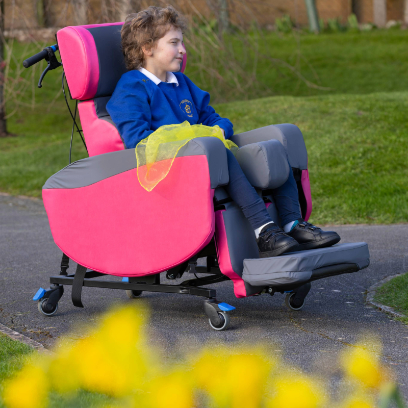 child sat in pink MultiAdjust outside