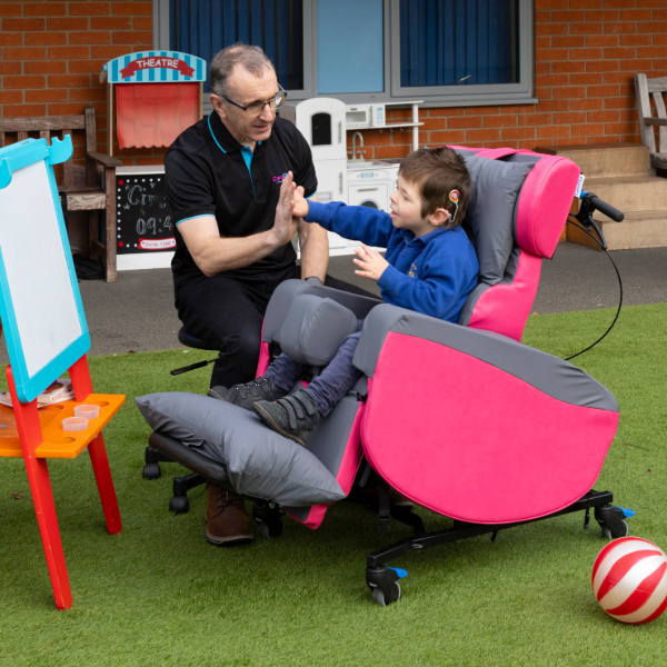 seating assessor and child in a pink multiadjust